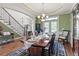 Gracious dining room featuring hardwood floors, stylish rug, and elegant furniture at 50 Cannonade Ct, Covington, GA 30016