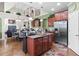 Eat-in kitchen with an island, stainless appliances, cherry cabinets, and an open floorplan at 50 Cannonade Ct, Covington, GA 30016