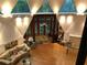 Well-lit living area showcasing triangular windows, a comfortable sofa, and stylish decor for a cozy and inviting ambiance at 5015 Wright Bridge Rd, Cumming, GA 30028