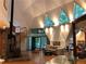 Spacious living room with wood floors, exposed stone, fireplace, spiral staircase, and unique triangular windows at 5015 Wright Bridge Rd, Cumming, GA 30028
