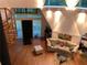 Living room with hardwood floors, a comfortable beige couch, and unique architectural details including a spiral staircase at 5015 Wright Bridge Rd, Cumming, GA 30028