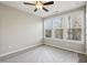 Bedroom with ceiling fan, three windows and neutral carpet at 1095 Tucker Ave # 401, Atlanta, GA 30310