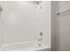 Close-up of the white subway tiled shower and tub with chrome fixtures at 1095 Tucker Ave # 401, Atlanta, GA 30310
