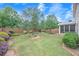 Fenced backyard featuring lush green grass, manicured landscaping, and mature trees at 236 Creek View Ln, Acworth, GA 30102