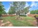 Spacious backyard with healthy green grass, mulch beds, beautiful landscaping and privacy fence at 236 Creek View Ln, Acworth, GA 30102