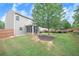 Rear view of the home and yard shows spacious lush grass, beautiful landscaping, and screen porch at 236 Creek View Ln, Acworth, GA 30102
