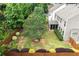 Spacious backyard with lush lawn, manicured landscaping, and a screened-in porch for outdoor enjoyment at 236 Creek View Ln, Acworth, GA 30102