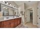 Bathroom boasting double sinks, vanity with cabinets, a large mirror, and a shower with a glass door at 236 Creek View Ln, Acworth, GA 30102