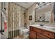 Neutral bathroom featuring a shower-tub combo, patterned shower curtain, and dark wood vanity at 236 Creek View Ln, Acworth, GA 30102