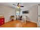Bedroom with a ceiling fan, desk, laminate flooring, and a black-and-white bulletin board at 236 Creek View Ln, Acworth, GA 30102