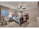 Carpeted bedroom with a ceiling fan, decorative chair, a dresser with a TV, and a window at 236 Creek View Ln, Acworth, GA 30102