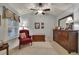 Relaxing bedroom with a ceiling fan, red chair, and nice furnishings at 236 Creek View Ln, Acworth, GA 30102