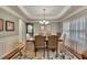 Formal dining room featuring a tray ceiling, hardwood floors, and elegant chandelier at 236 Creek View Ln, Acworth, GA 30102