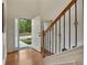 Bright foyer with hardwood floors and staircase with decorative iron spindles at 236 Creek View Ln, Acworth, GA 30102