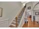 Elegant foyer with hardwood floors and a staircase with wrought iron detailing at 236 Creek View Ln, Acworth, GA 30102
