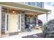 Inviting front porch featuring a stone facade, seating, and charming exterior lighting at 236 Creek View Ln, Acworth, GA 30102