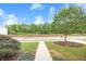 Landscaped front yard with mature tree and green lawn; home in background at 236 Creek View Ln, Acworth, GA 30102