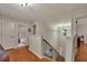 Bright hallway with wood floors, staircase, and access to multiple rooms at 236 Creek View Ln, Acworth, GA 30102