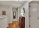 Upstairs hallway with hardwood floors and neutral colors, featuring a desk and access to rooms at 236 Creek View Ln, Acworth, GA 30102