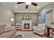 Comfortable living room showcases a fireplace, television, neutral colors, and ceiling fan at 236 Creek View Ln, Acworth, GA 30102