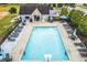 A full pool view is shown, featuring several lounge chairs, umbrellas, and a pool house at 236 Creek View Ln, Acworth, GA 30102