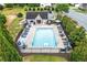 Aerial view of the pool shows tables with umbrellas, lounge chairs, and a pool house at 236 Creek View Ln, Acworth, GA 30102