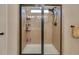 Neutral-toned bathroom featuring a walk-in shower with a sleek glass door and tile surround at 236 Creek View Ln, Acworth, GA 30102