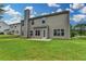Backyard features a well-maintained lawn, neutral siding, access door, and a chimney at 2421 Fall Creek Lndg, Loganville, GA 30052