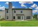 Backyard showcases verdant lawn, neutral siding, access door, and a chimney at 2421 Fall Creek Lndg, Loganville, GA 30052