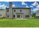 Backyard features a green lawn, neutral siding, access door, and a chimney at 2421 Fall Creek Lndg, Loganville, GA 30052