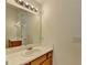 Bathroom with a vanity with a mirror and lights, a sink, and a door at 2421 Fall Creek Lndg, Loganville, GA 30052