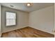 A bright bedroom featuring wood flooring and a window at 2421 Fall Creek Lndg, Loganville, GA 30052