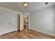 This bedroom features wood flooring, closet, and an open door at 2421 Fall Creek Lndg, Loganville, GA 30052