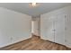 Clean bedroom featuring wood-look flooring, fresh white walls, and a double-door closet at 2421 Fall Creek Lndg, Loganville, GA 30052