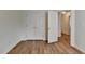 This bedroom features wood flooring, closet, and an open door at 2421 Fall Creek Lndg, Loganville, GA 30052