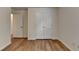 Empty bedroom showing wood-look flooring, fresh white walls, and a double-door closet at 2421 Fall Creek Lndg, Loganville, GA 30052