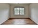 This bedroom offers wood flooring and a window providing natural light at 2421 Fall Creek Lndg, Loganville, GA 30052