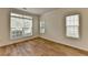 Bright bedroom featuring hardwood floors and natural light from multiple windows at 2421 Fall Creek Lndg, Loganville, GA 30052