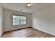 Cozy bedroom with wood flooring and natural light from a large window at 2421 Fall Creek Lndg, Loganville, GA 30052