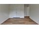 This bedroom features wood flooring, closet, and an open door at 2421 Fall Creek Lndg, Loganville, GA 30052