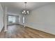 Elegant dining area featuring a chandelier, hardwood floors, and decorative trim at 2421 Fall Creek Lndg, Loganville, GA 30052