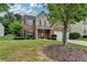 Charming two-story home featuring a brick facade, attached two-car garage, and well-manicured lawn at 2421 Fall Creek Lndg, Loganville, GA 30052