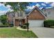 Charming two-story home featuring a brick facade, attached two-car garage, and well-manicured lawn at 2421 Fall Creek Lndg, Loganville, GA 30052