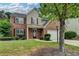 Charming two-story home featuring a brick facade, attached two-car garage, and well-manicured lawn at 2421 Fall Creek Lndg, Loganville, GA 30052