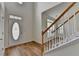 Bright foyer with hardwood floors, staircase, and a front door with decorative glass at 2421 Fall Creek Lndg, Loganville, GA 30052