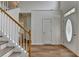 Bright foyer with hardwood floors, staircase, and a front door with decorative glass at 2421 Fall Creek Lndg, Loganville, GA 30052