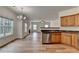 Open kitchen layout features hardwood floors, and a view into the living room with a fireplace at 2421 Fall Creek Lndg, Loganville, GA 30052