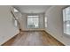 Inviting living room with hardwood floors and large windows offering ample natural light at 2421 Fall Creek Lndg, Loganville, GA 30052