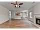 Spacious living room with wood floors, ceiling fan, open layout, and easy access to other rooms at 2421 Fall Creek Lndg, Loganville, GA 30052