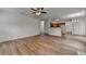 Spacious living room with wood floors, ceiling fan, open layout, and easy access to other rooms at 2421 Fall Creek Lndg, Loganville, GA 30052